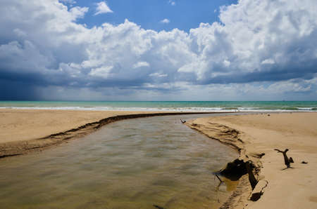 Sandy beach with blue sky and cloudsの写真素材