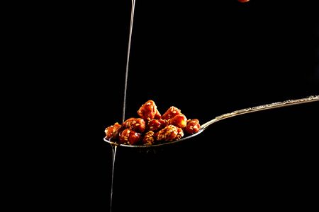 closeup of sugar peanuts on a black backgroundの写真素材