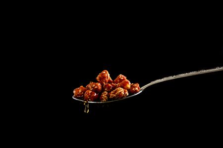 closeup of sugar peanuts on a black backgroundの写真素材