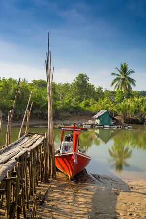 Small fishing boats and harbor bridge into the riverの写真素材