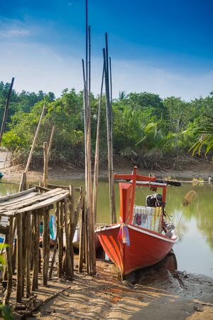 Small fishing boats and harbor bridge into the riverの写真素材
