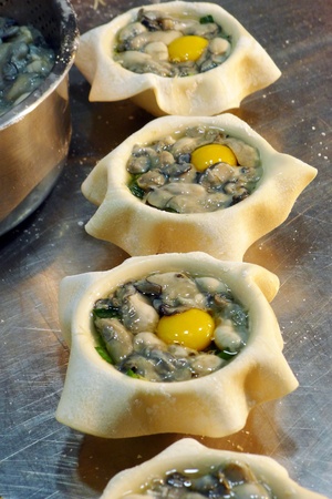 Fresh Oyster with egg in wrapper, waiting to be deep-fried into Gold colorの写真素材