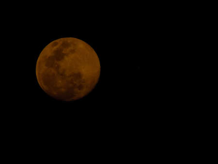 Full red moon with dark backgroundの写真素材