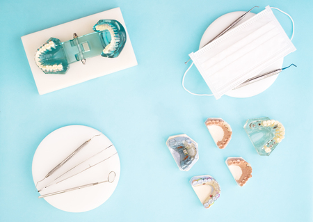 dentist tools and prosthodontic on color background, flat lay, top vipw.の写真素材
