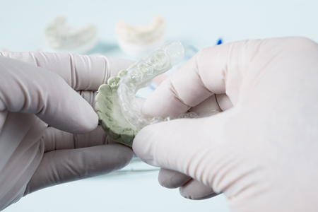 Dental  retainer orthodontic appliance on the blue background.の写真素材