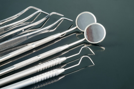 Dental tools use for dentist in the office or clinic. On the black background.の写真素材