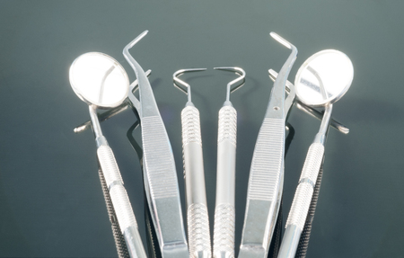 Dental tools use for dentist in the office or clinic. On the black background.の写真素材