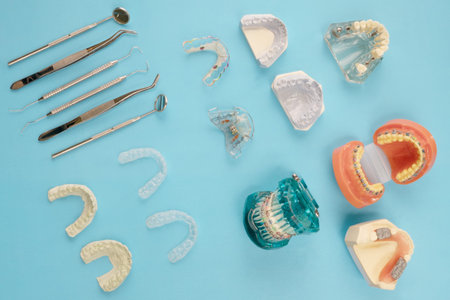 dentist tools and orthodontic on the  blue background, flat lay, top vipw.