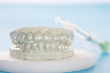Dental retainer orthodontic appliance on the blue background.の写真素材