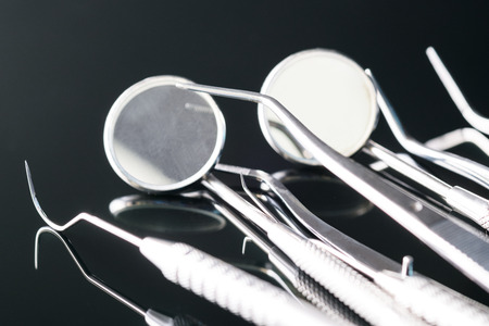 Dental tools use for dentist in the office or clinic. On the black background.の写真素材