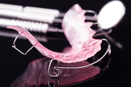 Dental  tools  and retainer orthodontic appliance on the black background.の写真素材