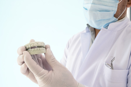 The dentist explains about how to use the retainer.の写真素材