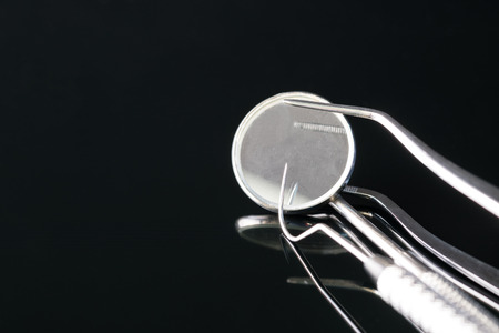 Dental tools use for dentist in the office or clinic. On the black background.の写真素材