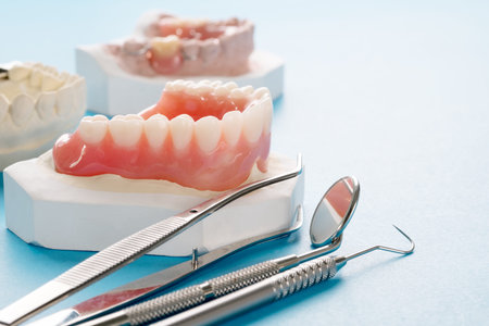 Close up , Complete denture or full denture on blue background.