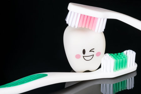 Close up; Dental tools and smile teeth model on black background.
