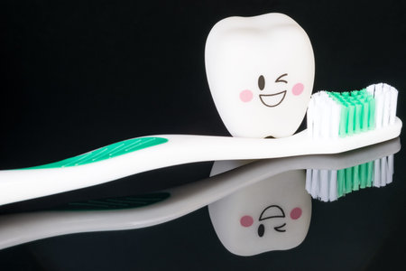Close up; Dental tools and smile teeth model on black background.の写真素材