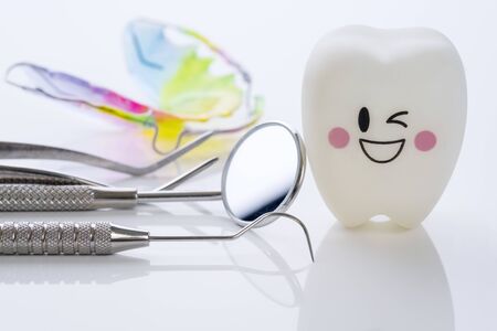 Close up.Dental tools and smile teeth model on white background.の写真素材