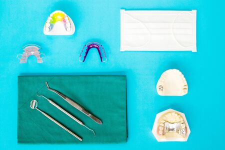 Dental  tools  and retainer orthodontic appliance on the blue background, flat lay, top vipw.の写真素材