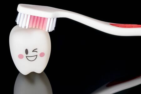 Close up, Dental tools and smile teeth model on black background.の写真素材
