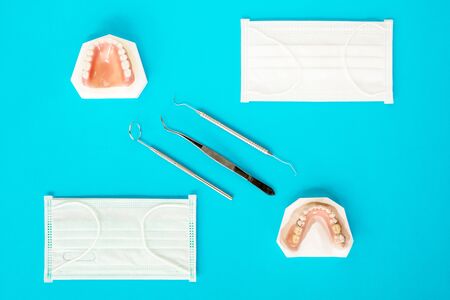 Artificial removable partial denture or temporary partial denture on blue ground, flat lay, top vipw.の写真素材