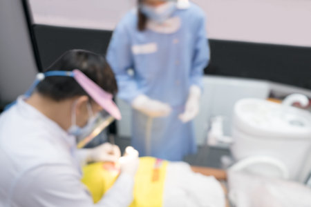 Blurred image photo of dentist and his assistant are working in clinic.の写真素材