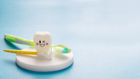 Dental tools and smile teeth model on blue background.