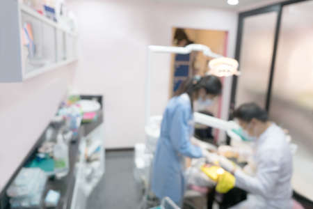 Blurred image photo of dentist and his assistant are working in clinic.の写真素材