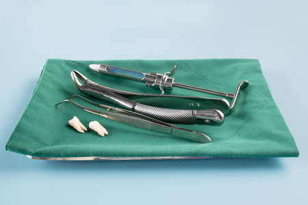 Dentistry medical tools forcept on blue background.の写真素材