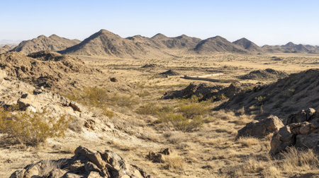 A stunning desert landscape featuring rocky terrain and distant mountains under a clear sky. Ideal for outdoor, nature, and travel themes.の素材