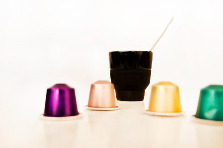 Colorful plastic coffee cups on a white background. Selective focus.