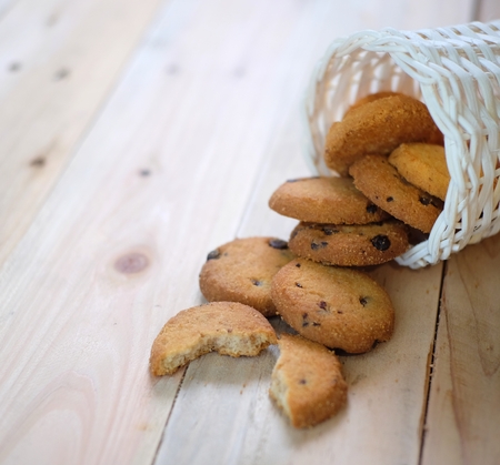 Stack of tasty choc chip cookies on wooden tableの写真素材