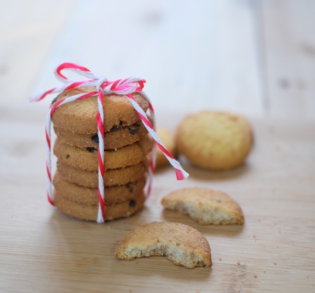 Stack of tasty choc chip cookies on wooden tableの写真素材