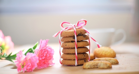 Stack of tasty choc chip cookies on wooden tableの写真素材