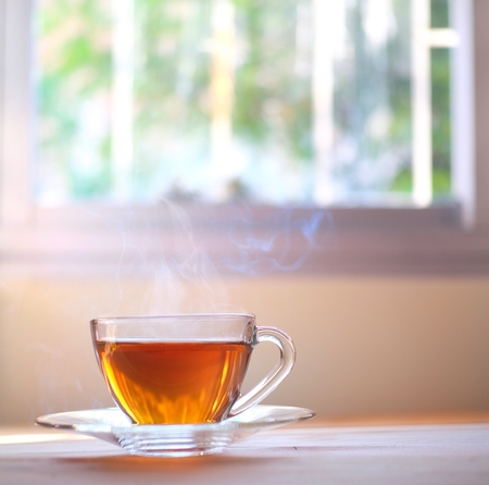 Hot tea steam smoke with window background.の写真素材