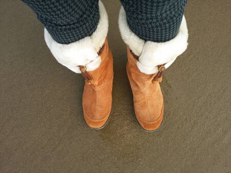 Wearing boots on the beachの写真素材