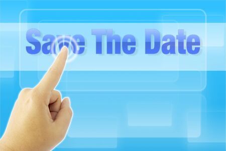touching Save The Date sign on blue screenの写真素材
