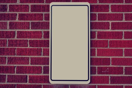Red brick wall with blank signの写真素材