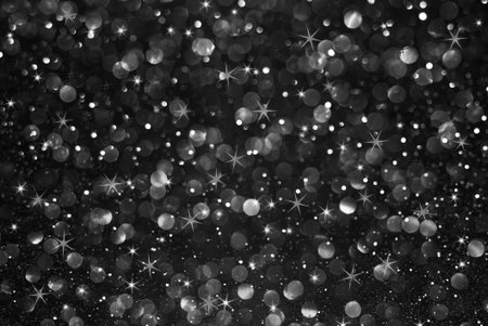 black glitter bokeh with stars abstract backgroundの写真素材