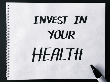 Invest in your health on white paper in black and whiteの写真素材