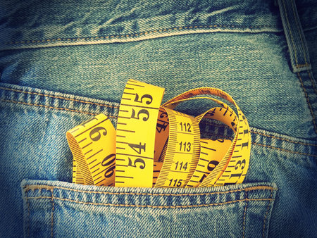 measuring tape in the pocket of blue denim jeans retro style