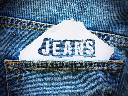 jeans word on white paper in the pocket of blue denim jeansの写真素材