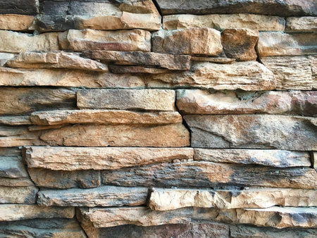 uneven cracked stone wall texture background
