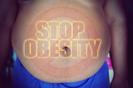 Fat man with a big belly, with words stop obesityの写真素材