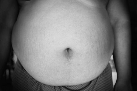 Fat man with a big belly, diet concept, black and white styleの写真素材