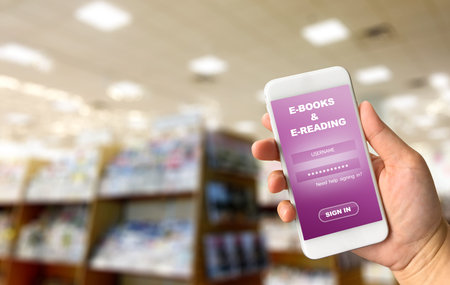 Woman hand holding smartphone against blurred of library background, E-learning concept