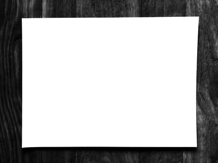 Blank white paper on blurred of black wooden backgroundの写真素材