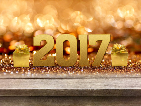 Gold gift box and ribbon with word 2017 on wood table, bokeh background