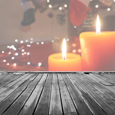 Wood table top on Christmas decoration with candles background