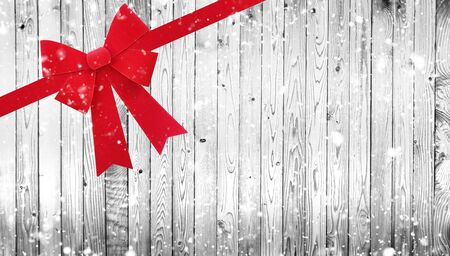Red Christmas bow on wooden backgroundの写真素材