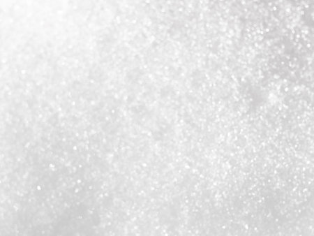 Natural glitter bokeh lights from fresh snow, defocused blur backgroundの写真素材